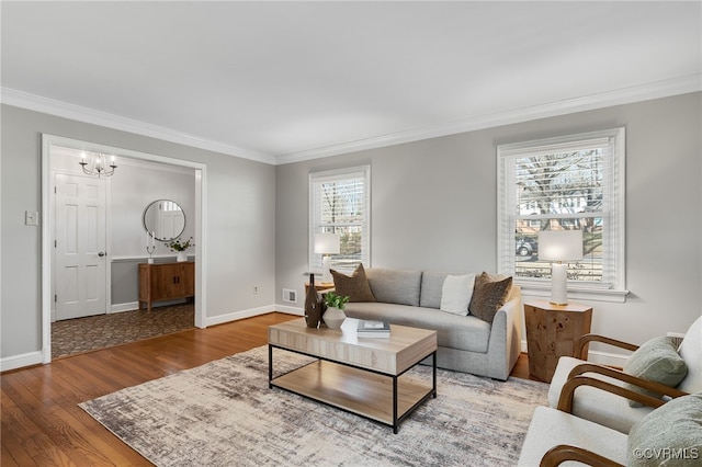 living room with baseboards, wood finished floors, and ornamental molding