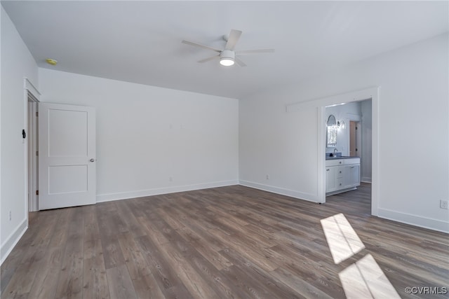 unfurnished living room featuring baseboards, dark wood-style flooring, and ceiling fan