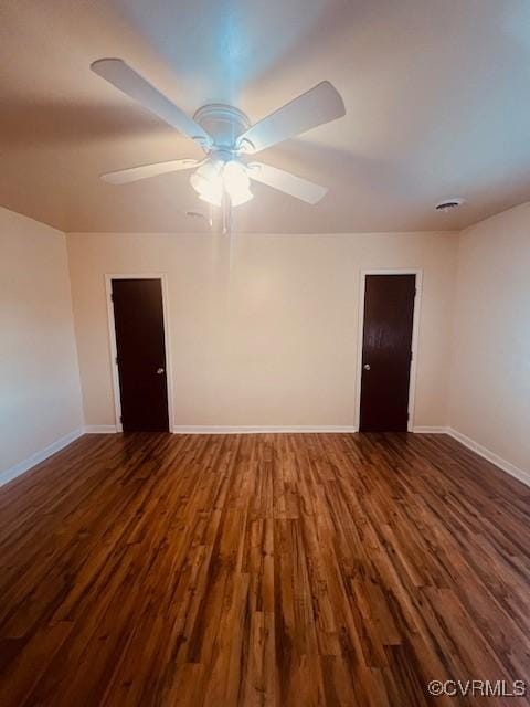 empty room featuring a ceiling fan, wood finished floors, and baseboards