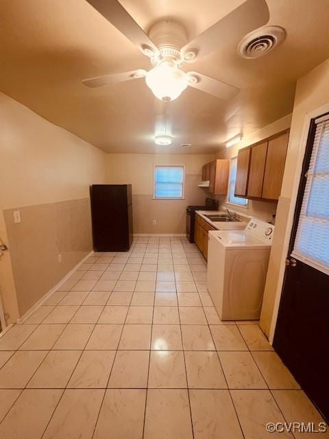 kitchen with visible vents, ceiling fan, light countertops, light tile patterned floors, and a sink