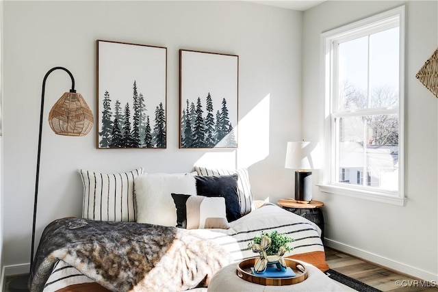 bedroom featuring wood finished floors and baseboards