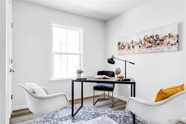 office space featuring baseboards and wood finished floors