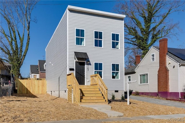 view of front of house featuring crawl space and fence