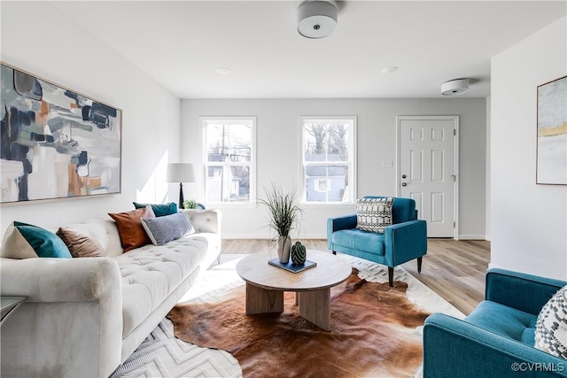 living area featuring baseboards and wood finished floors