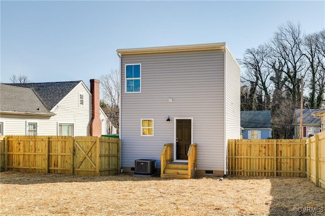 rear view of house featuring crawl space, central air condition unit, and fence