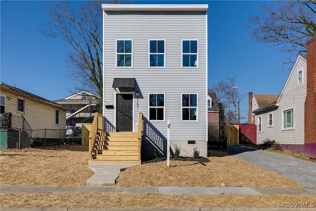 view of front of home featuring crawl space and fence