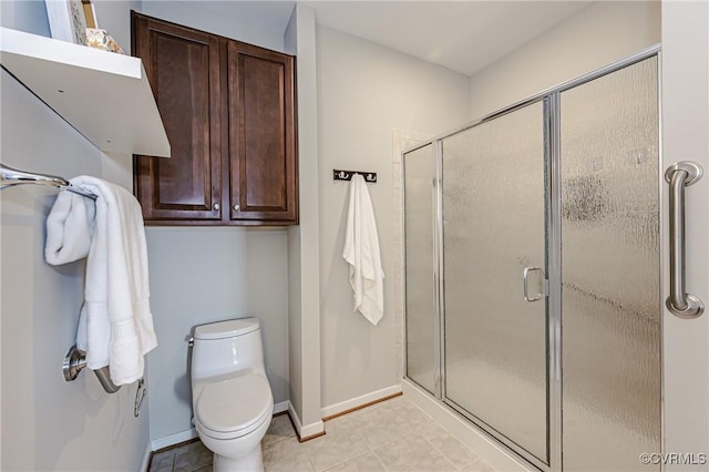 full bathroom featuring a shower stall, baseboards, and tile patterned floors