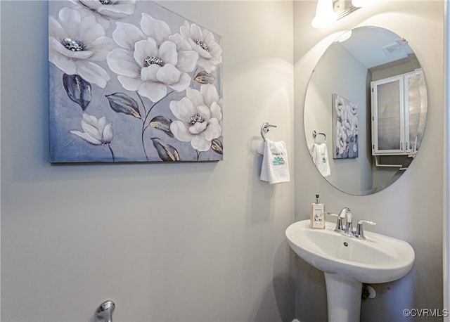 bathroom with visible vents and a sink