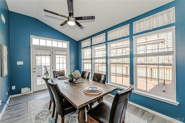 dining space with vaulted ceiling, wood finished floors, baseboards, and ceiling fan