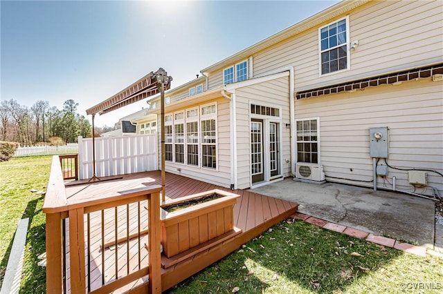 exterior space featuring fence, a lawn, and a wooden deck