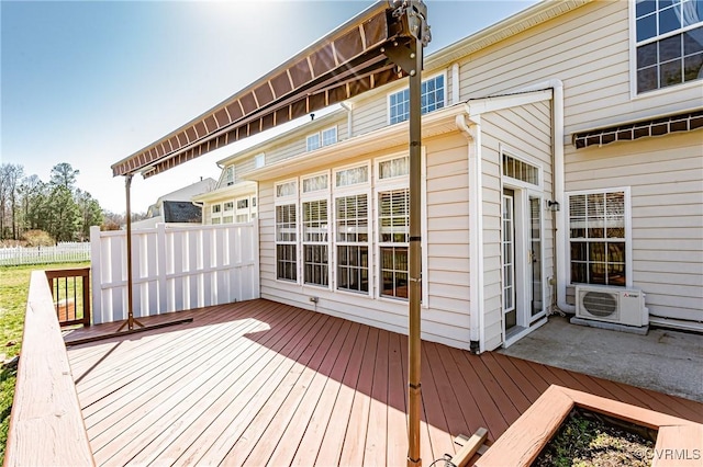 wooden terrace with ac unit and fence