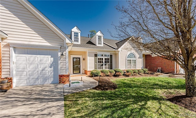 view of front of house with a front lawn, concrete driveway, brick siding, and an attached garage