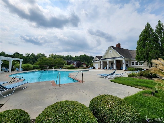 pool with a pergola and a patio