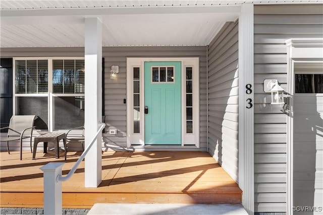 property entrance featuring a garage and covered porch