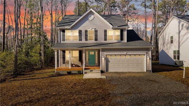 traditional-style home with cooling unit, a porch, and driveway