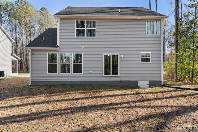 back of property featuring roof with shingles