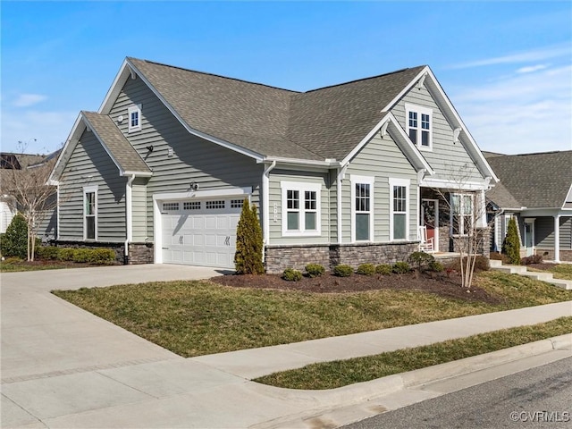 view of front of house with concrete driveway, an attached garage, stone siding, and roof with shingles