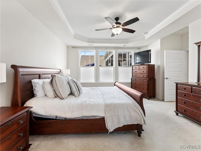 bedroom featuring a raised ceiling, a ceiling fan, light carpet, and crown molding