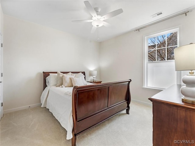 bedroom featuring a ceiling fan, baseboards, visible vents, and light carpet