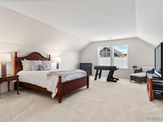 bedroom with baseboards, lofted ceiling, and light colored carpet