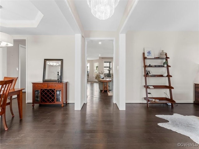 foyer featuring recessed lighting, a notable chandelier, wood finished floors, and baseboards