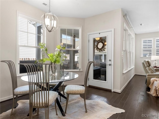 dining room featuring visible vents, baseboards, an inviting chandelier, and dark wood-style flooring