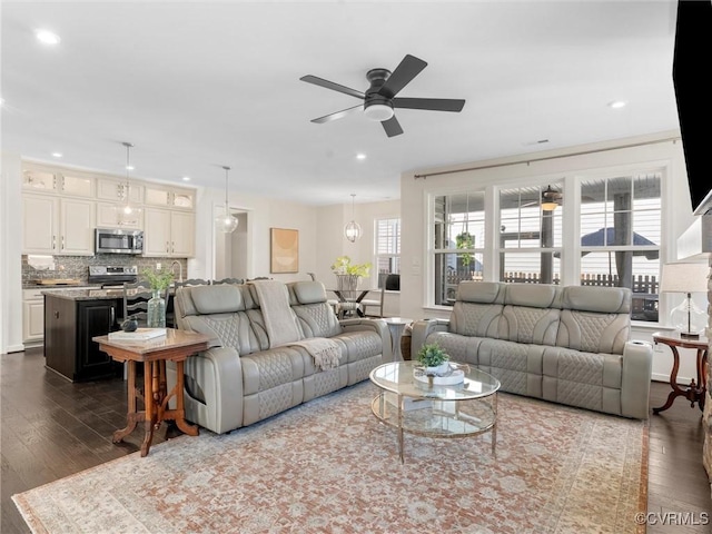 living room featuring dark wood finished floors, recessed lighting, and a ceiling fan