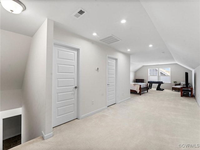 additional living space featuring visible vents, baseboards, vaulted ceiling, light carpet, and recessed lighting