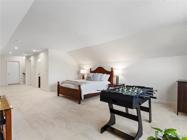 bedroom with vaulted ceiling, baseboards, and light carpet