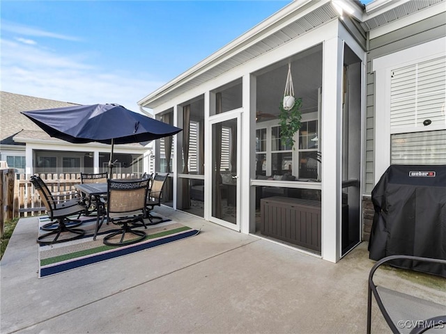 view of patio / terrace with outdoor dining space, fence, a sunroom, and a grill