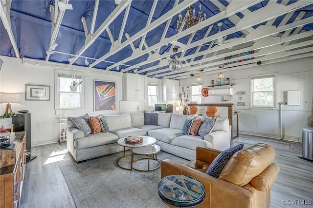 living area with a healthy amount of sunlight and wood finished floors