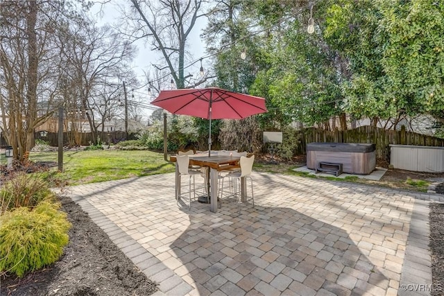 view of patio / terrace with a fenced backyard and a hot tub