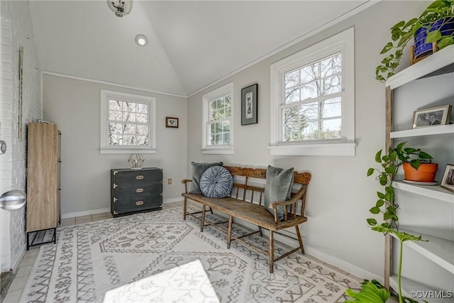 sitting room with tile patterned flooring, baseboards, and vaulted ceiling