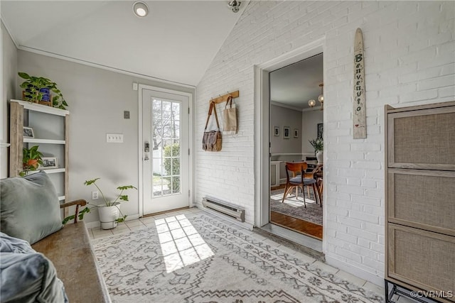 entryway with vaulted ceiling, light tile patterned flooring, crown molding, and brick wall