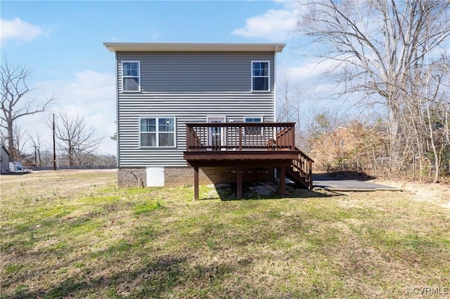 rear view of house with a deck, stairway, and a yard