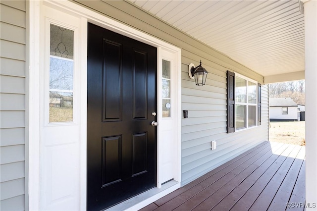 view of exterior entry with a porch