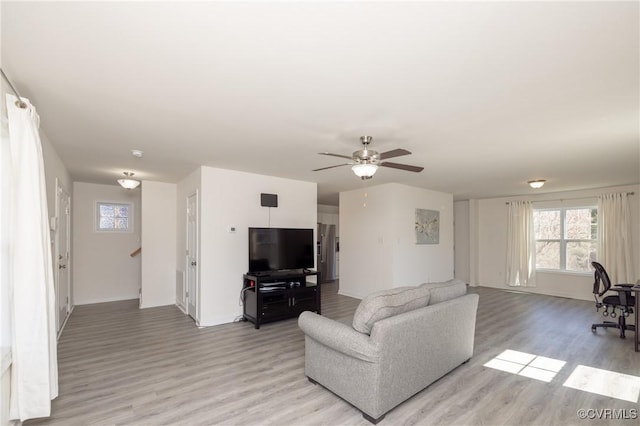 living room featuring ceiling fan and light wood-style floors