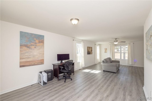 office area with baseboards and wood finished floors