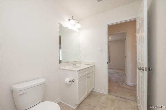 half bath featuring baseboards, toilet, and vanity