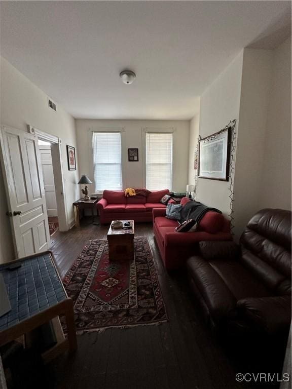 living room with wood finished floors and visible vents