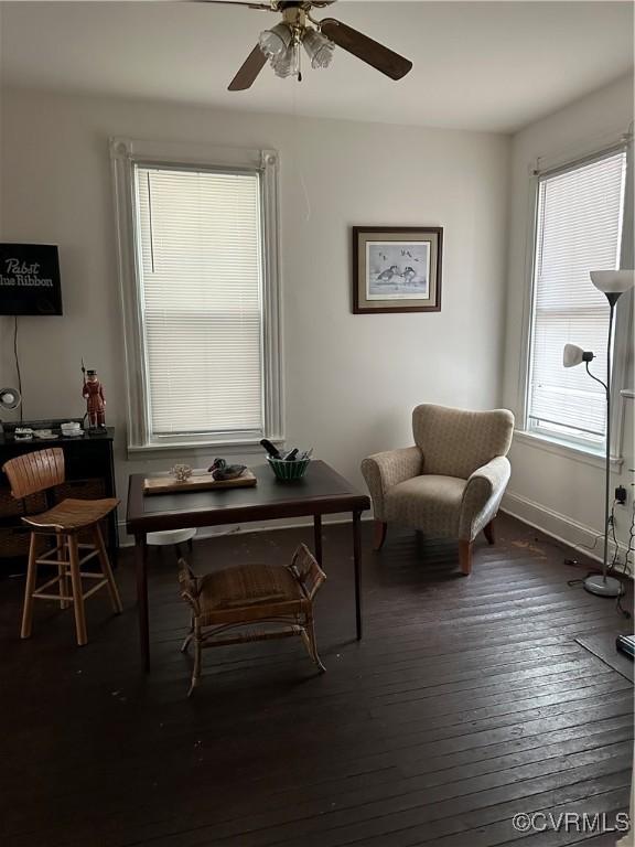 sitting room featuring hardwood / wood-style floors, a ceiling fan, and baseboards