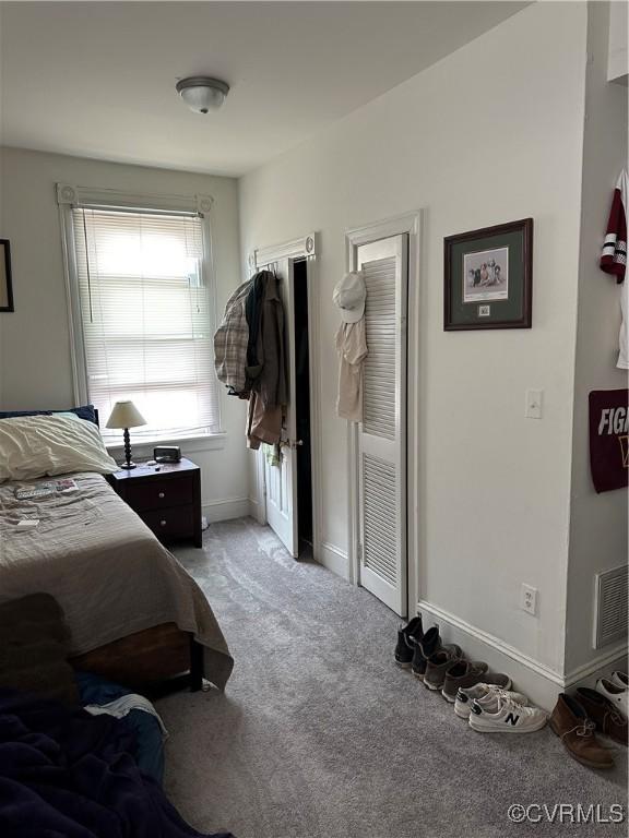 bedroom with visible vents, baseboards, and carpet floors