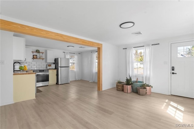 kitchen featuring a healthy amount of sunlight, light wood-style floors, and stainless steel appliances