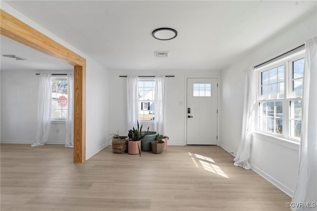 foyer with visible vents, a healthy amount of sunlight, and light wood-style flooring