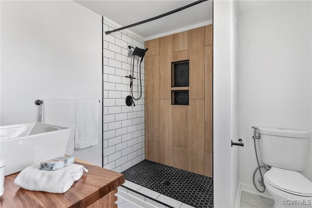 bathroom featuring a shower stall, toilet, marble finish floor, and baseboards