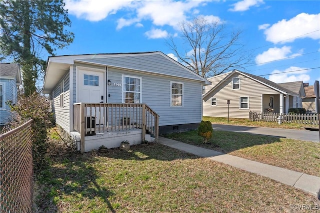 bungalow-style home featuring crawl space, a front yard, and fence