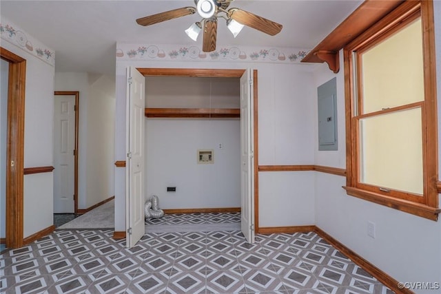 laundry area with washer hookup, electric panel, a ceiling fan, and baseboards