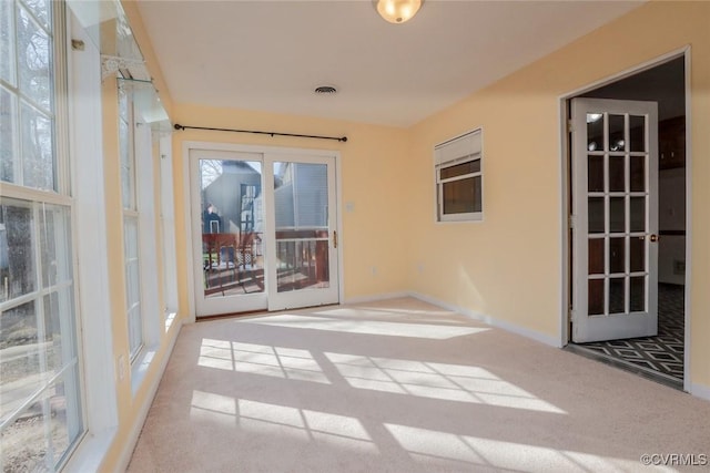 unfurnished sunroom with visible vents