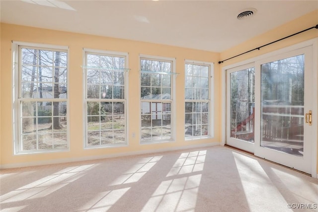 unfurnished sunroom featuring visible vents