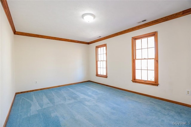 spare room with visible vents, baseboards, carpet, and ornamental molding